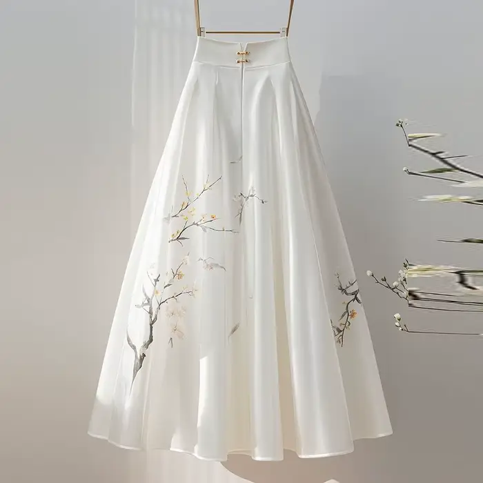 Jupe midi blanche avec un sentiment de drapé pour les femmes d'automne 2025, nouveau style super fée